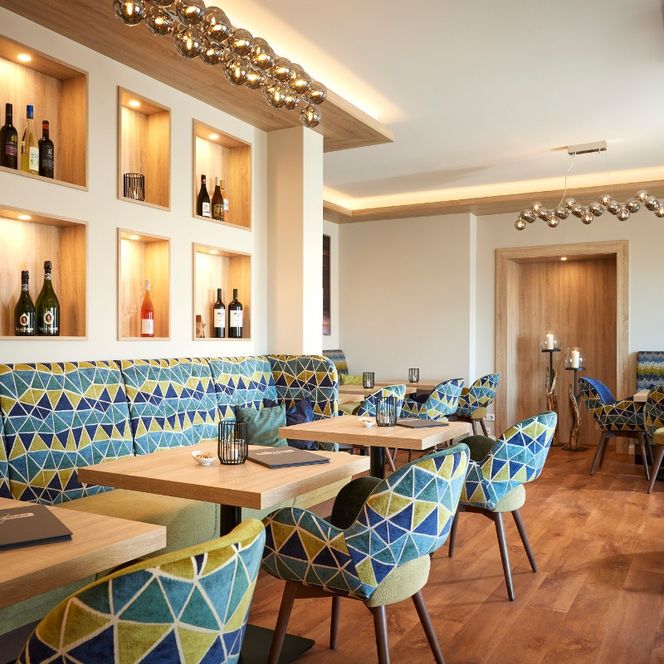 Einige Tische und Stühle im Restaurant des Hotels. 
