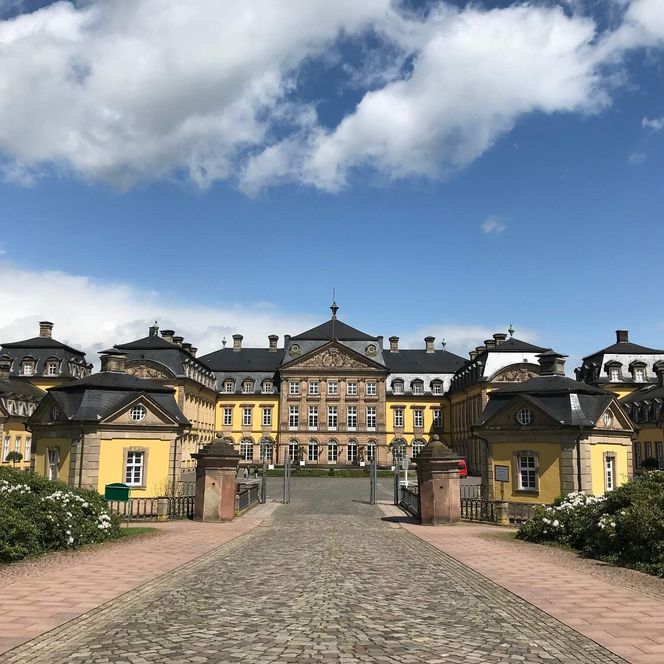 Ansicht des Residenzschlosses in Bad Arolsen vom Schlossplatz aus vor imposanter Wolkenkulisse 